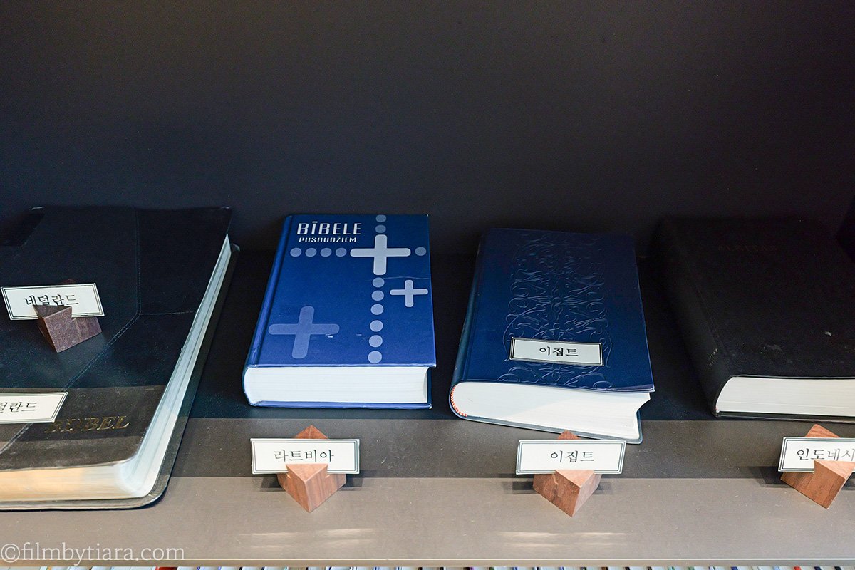 Bibles printed in different languages displayed on a shelf at FOREST AG405 library