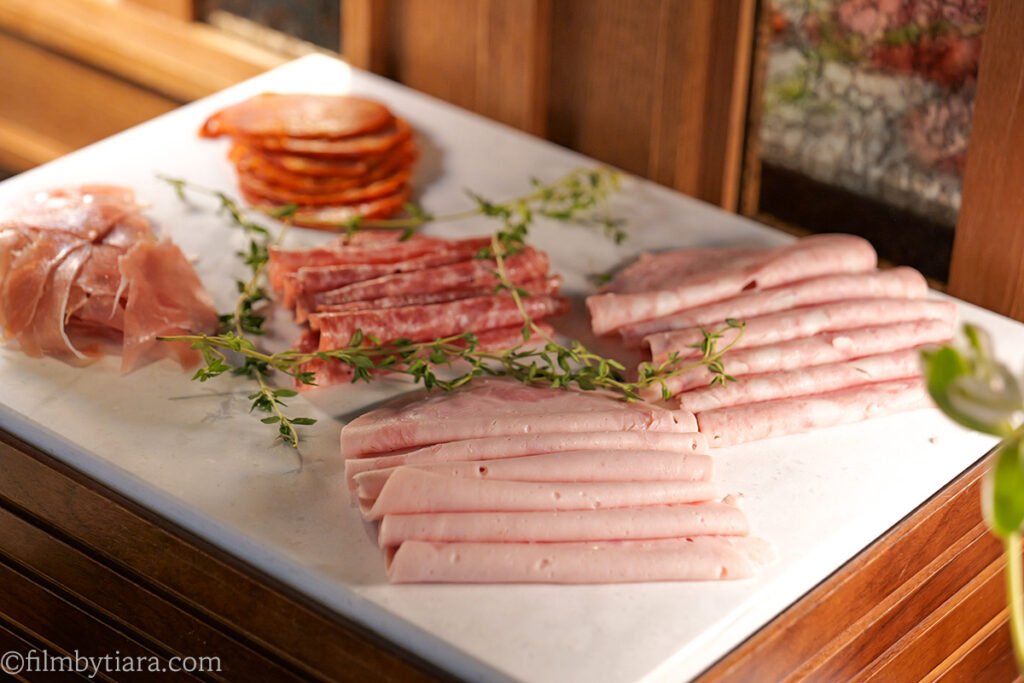 Charcuterie platter with prosciutto and salami at La Palette Paris buffet