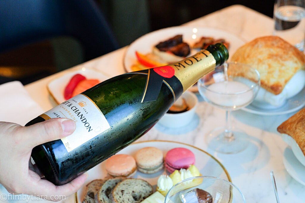 Pouring Moet Chandon champagne at La Palette Paris table setting