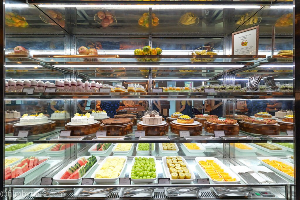 Fresh fruit and cake display case at La Palette Paris dessert bar