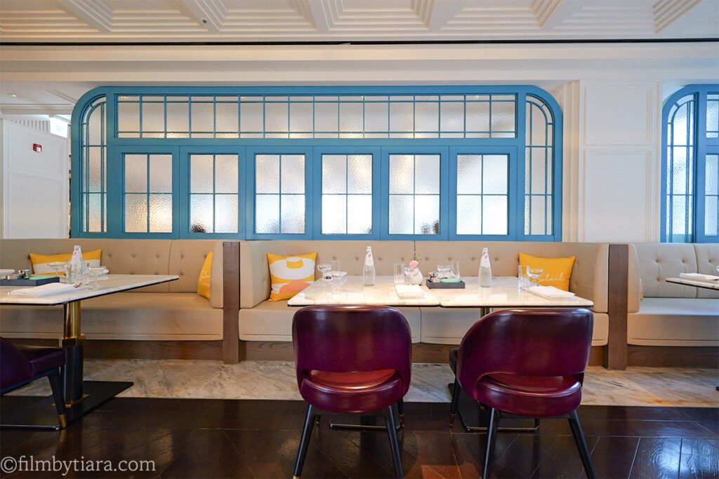 French-style dining nook with blue arched windows at La Palette Paris Title: La Palette Paris Dining Nook