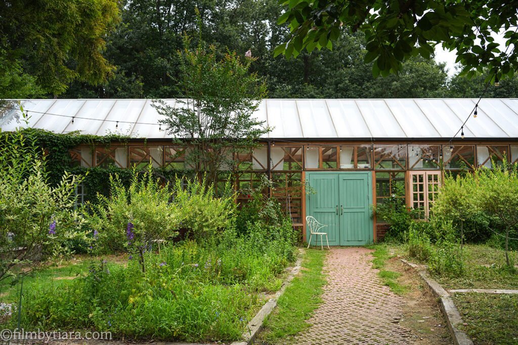Greenhouse exterior with mint-green doors at The Fore cafe Hwaseong