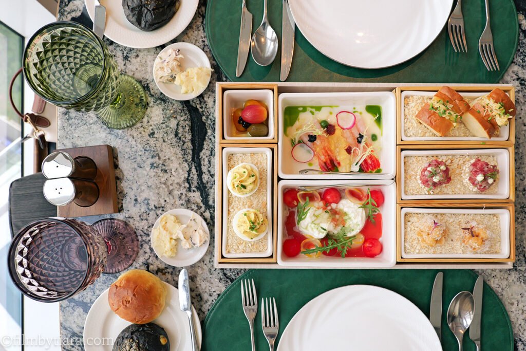 Appetizer box with seven bite-sized dishes at Restaurant Voisin