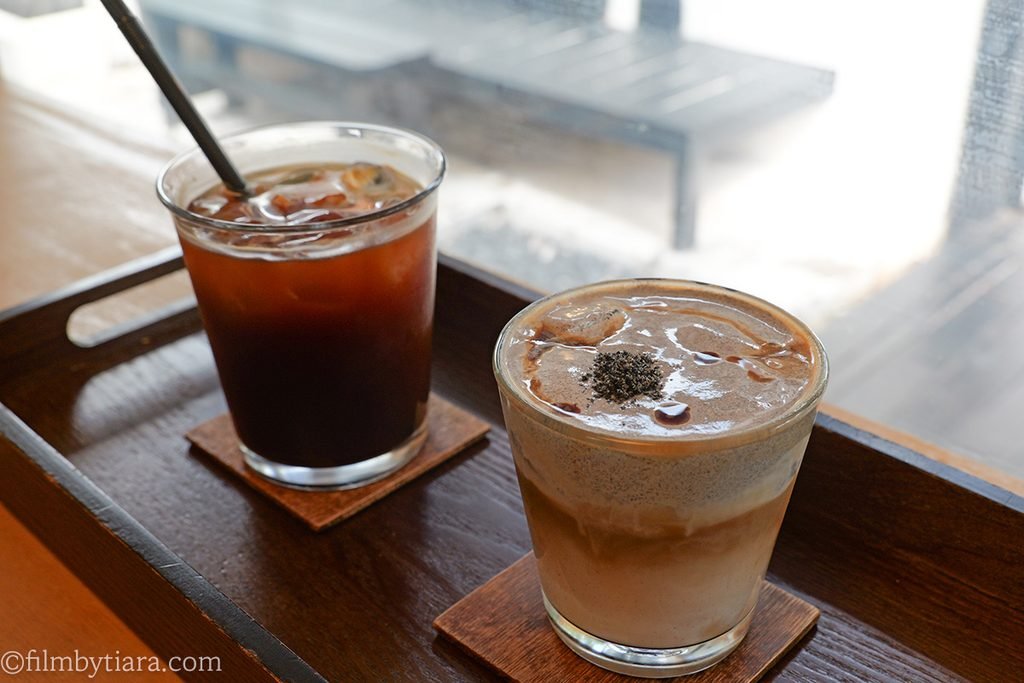 Close-up of signature Gomae Cream Coffee topped with rich black sesame cream