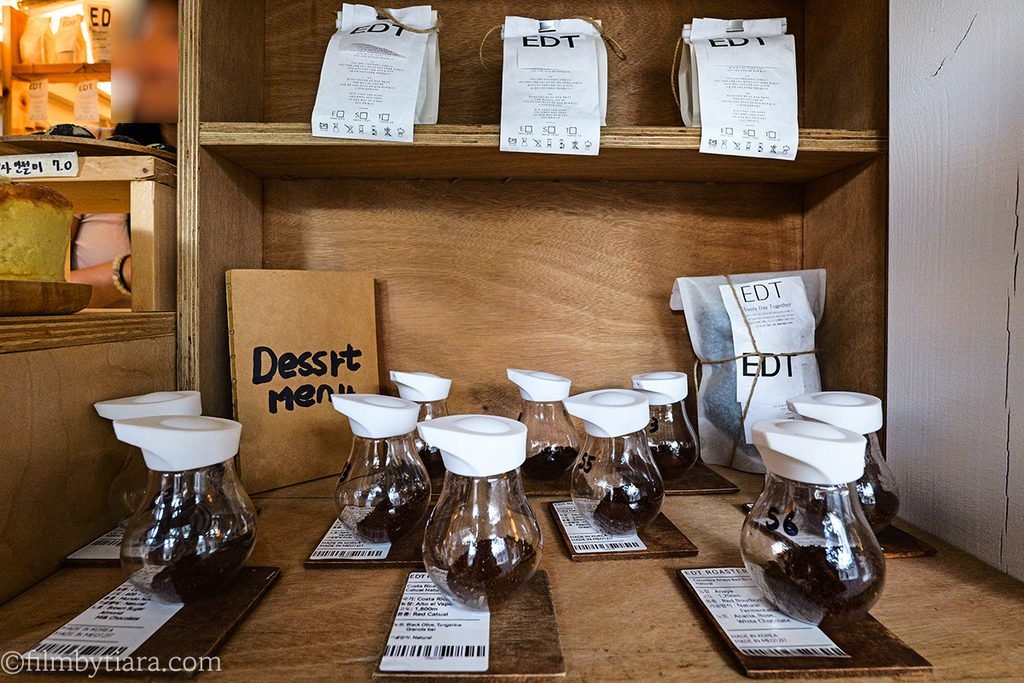 Glass jars with single-origin coffee bean samples and tasting notes