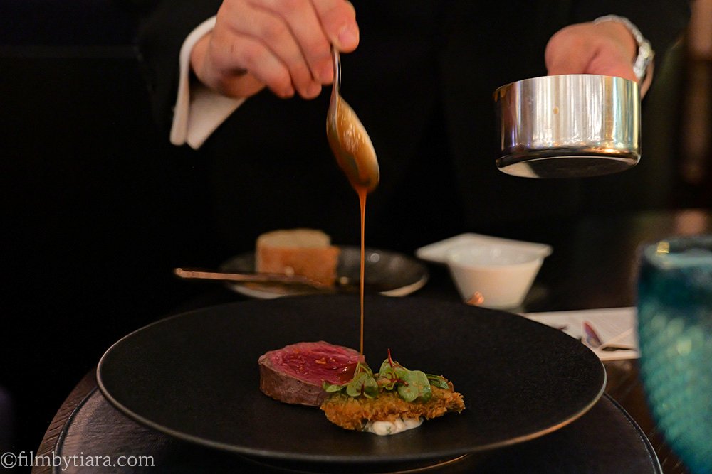 Premium 1++ Hanwoo beef tenderloin grilled over charcoal with chestnut jus at Mariposa.